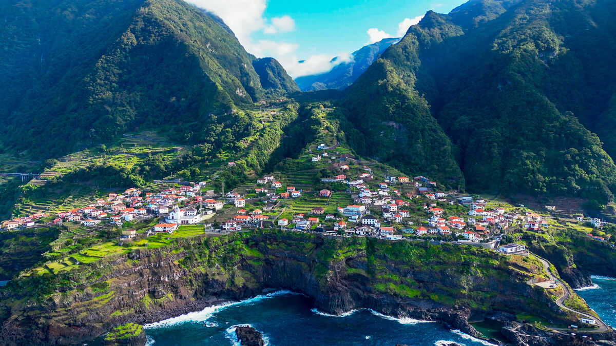 Drone shot of the village seixal with coastline, green nature and ocean view