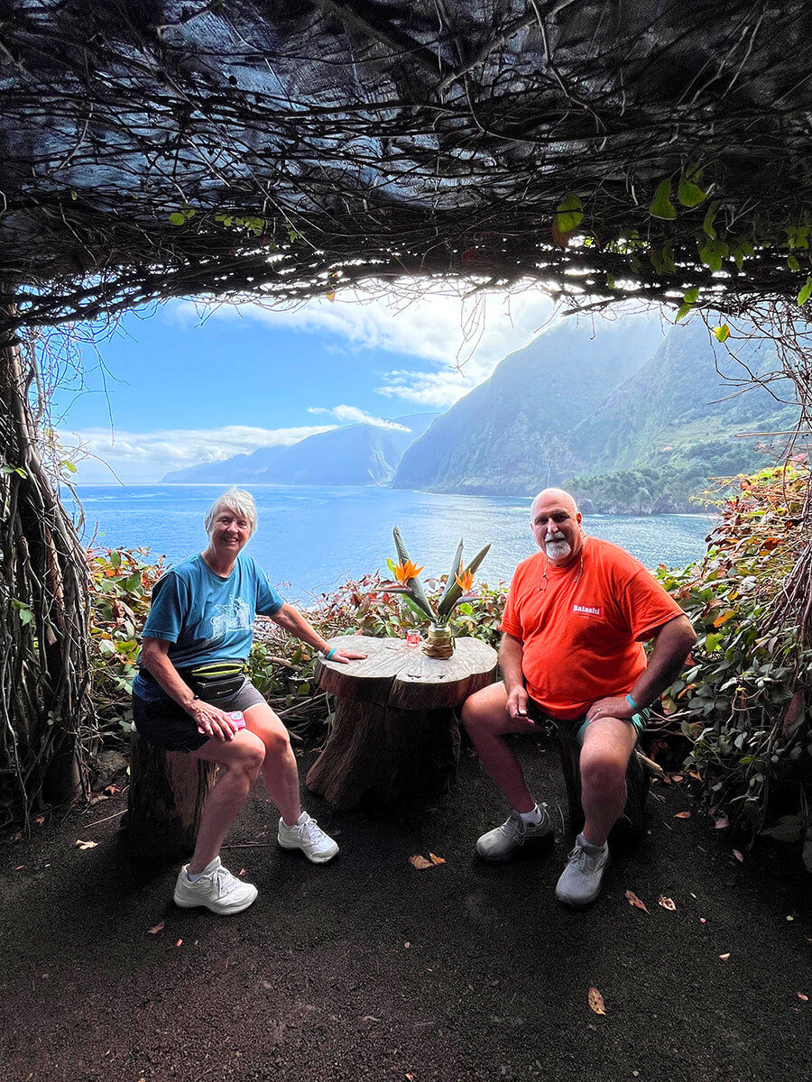 A massive waterfall dropping from a high cliff surrounded by green nature